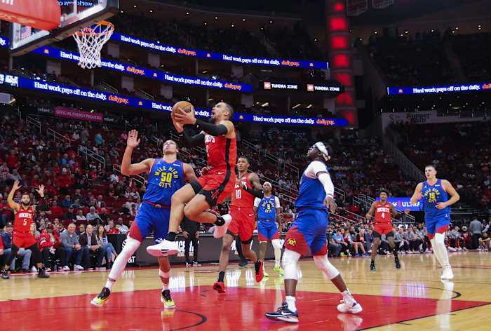 Rockets forward Dillon Brooks drives against Denver Nuggets forward Aaron Gordon (50) in the first quarter at Toyota Center.